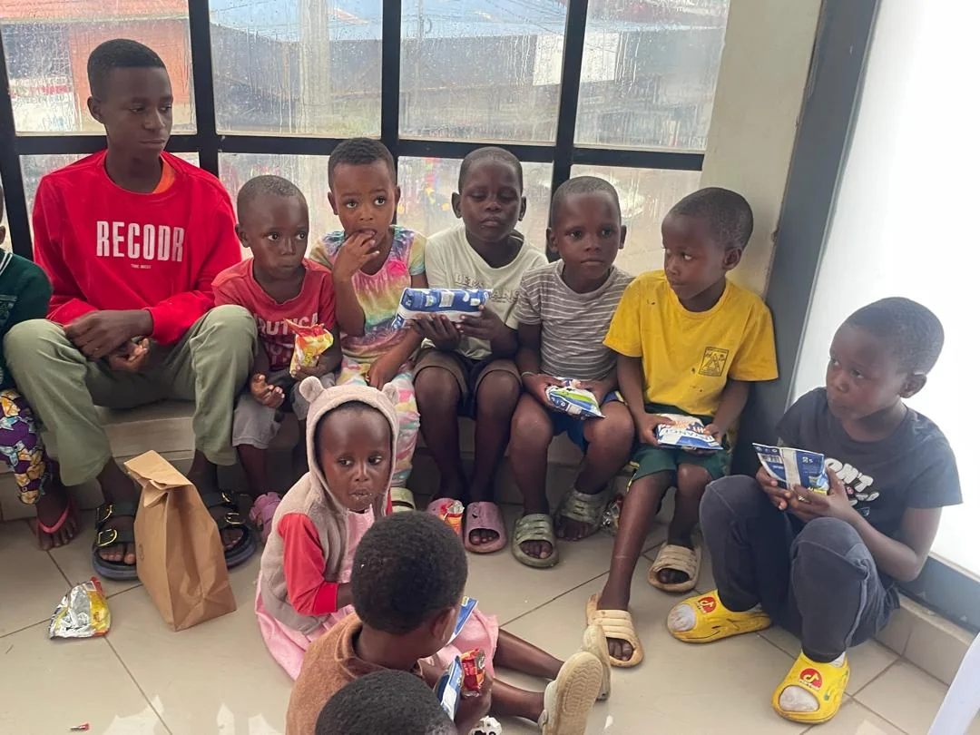 Children seated together with refreshments during an official BaBra Foundation support visit